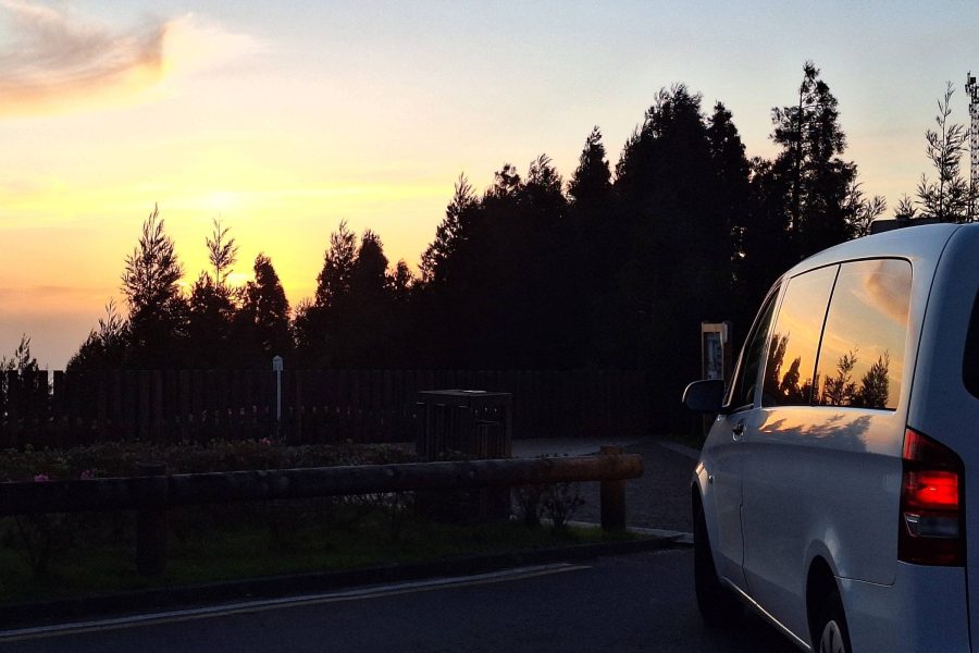 minivan sotped at miradouro vista do rei with sunset