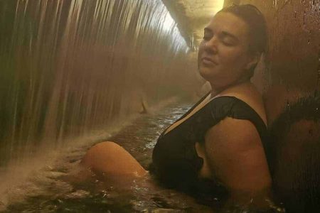 tourist relaxing at Dona beija thermal pool at nigh in furnas volcano, Azores