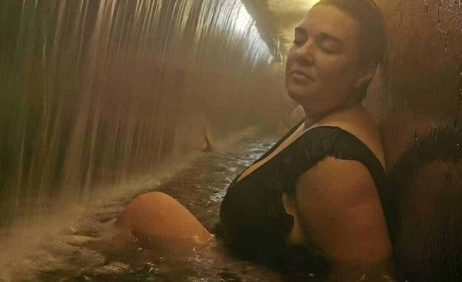 tourist relaxing at Dona beija thermal pool at nigh in furnas volcano, Azores